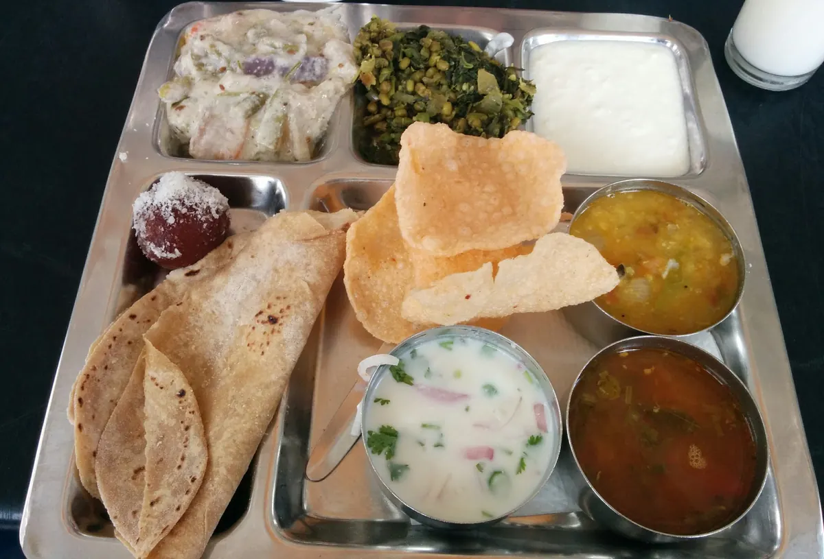 Vegetarian meals with rice, sambar, rasam, poriyal and sides
