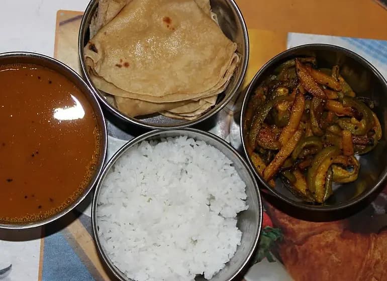 Organised Indian tiffin lunch box with multiple packed meal portions